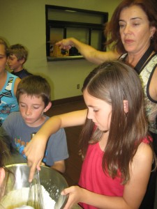 Kids make crepes at Basque camp.