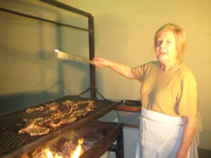 Danielle Arretche Osowiecki tends the lamb chops for the Chalet's monthly barbecue