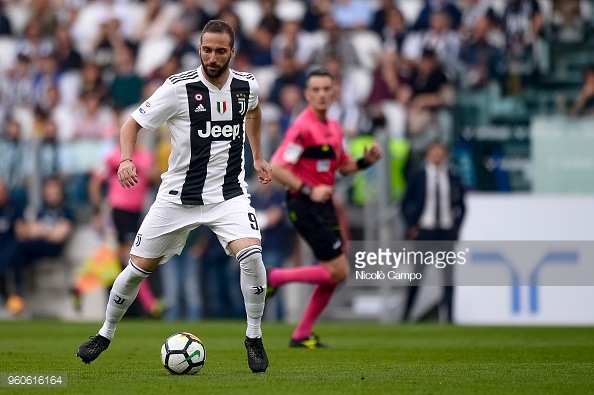 Basque soccer player Gonzalo Higuain kicking the soccer ball