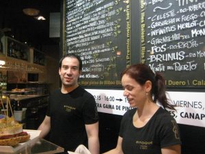 man and woman making food in restaurant