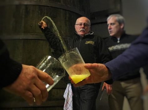 Txotx time, when the cider is released from the barrel. Here by owner Jose Angel Goñi