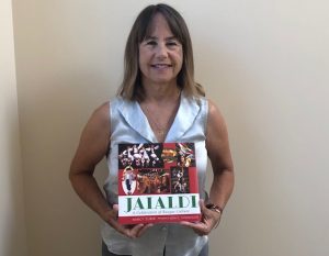 Author Nancy Zubiri holding the book "Jaialdi: A Celebration of Basque Culture"