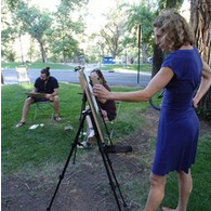 Artist Zoe Bray paints with students near a tree