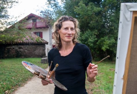 Artist Zoe Bray holds a paint brush