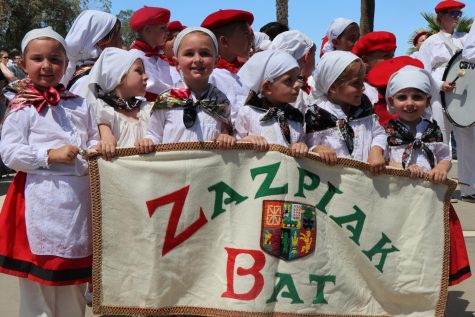 Young Basque dancers in red and white costumes.
