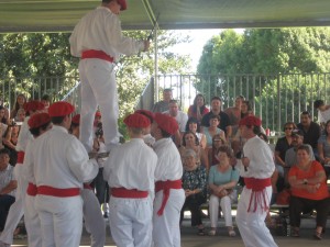 Boys lift a dancer up on their swords.