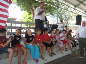 Dominic Echeberria emceed the afternoon dance show, while the younger crowd looks on.