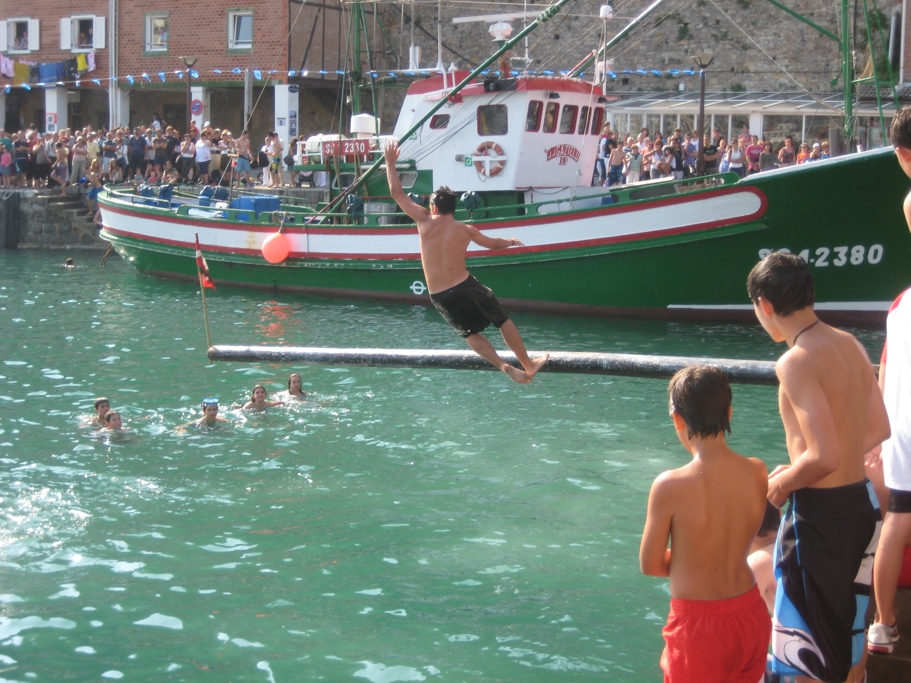 Man falls off greased ships mast during competition at port of San Sebastian